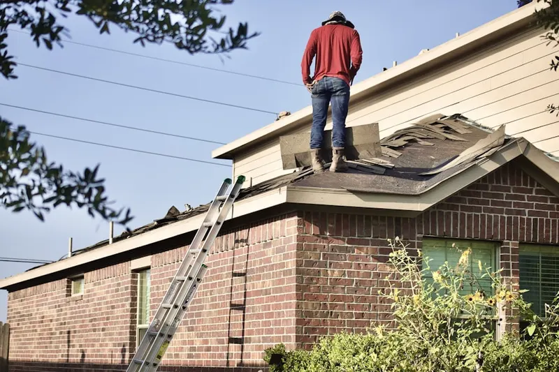 Professional roofer working on a residential roof in La Center